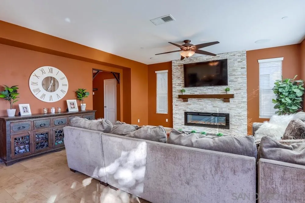 10005 Day Creek Trail Santee, CA 92071 - Photo 11 of 45 a living room with furniture a fireplace and a flat screen tv