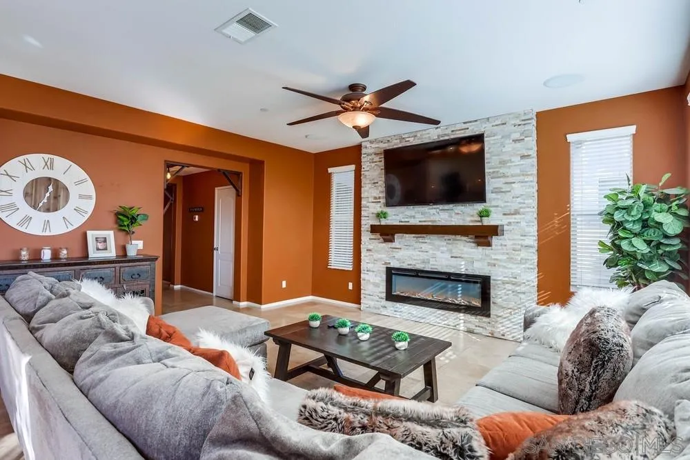 10005 Day Creek Trail Santee, CA 92071 - Photo 12 of 45 a living room with furniture a flat screen tv and a fireplace