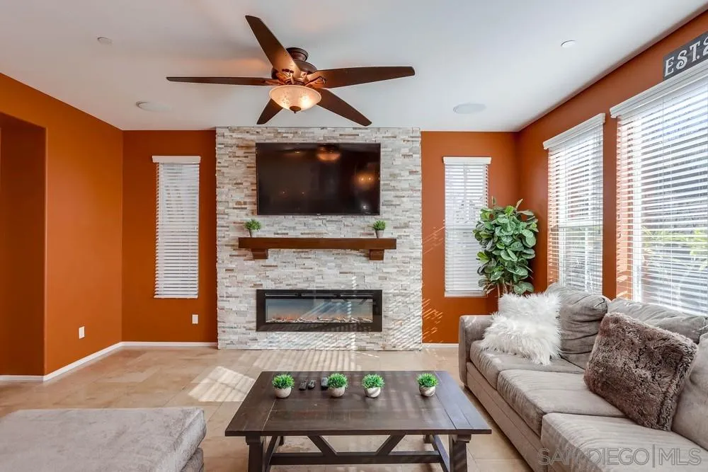 10005 Day Creek Trail Santee, CA 92071 - Photo 13 of 45 a living room with furniture a flat screen tv and a fireplace