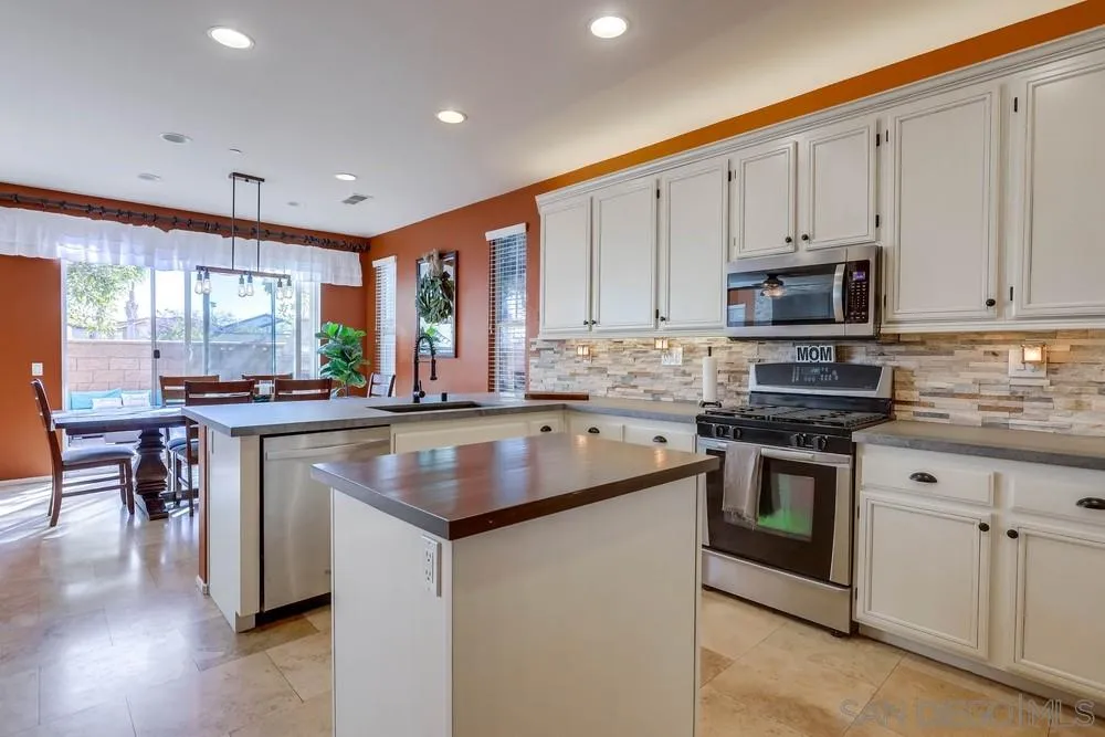 10005 Day Creek Trail Santee, CA 92071 - Photo 21 of 45 a kitchen with stainless steel appliances granite countertop a stove a sink and a refrigerator