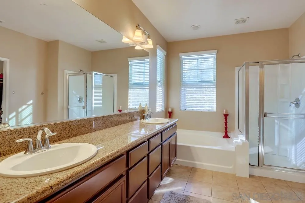 10005 Day Creek Trail Santee, CA 92071 - Photo 29 of 45 a spacious bathroom with sinks double vanity and a bathtub