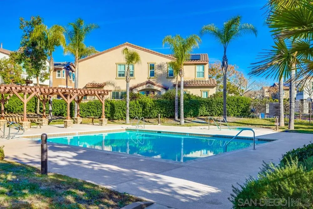 10005 Day Creek Trail Santee, CA 92071 - Photo 41 of 45 a view of a swimming pool with a lawn chairs under palm trees