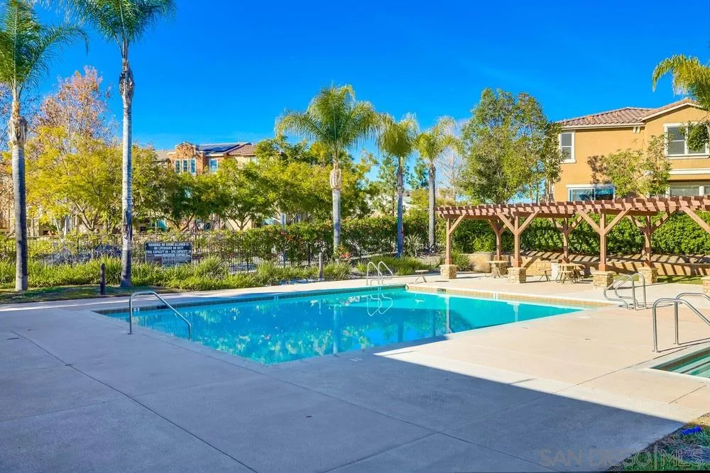 10005 Day Creek Trail Santee, CA 92071 - Photo 42 of 45 a view of a swimming pool with a lawn chairs and palm trees