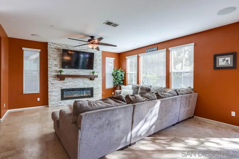 10005 Day Creek Trail Santee, CA 92071 - Photo 9 of 45 a living room with furniture a flat screen tv and a fireplace