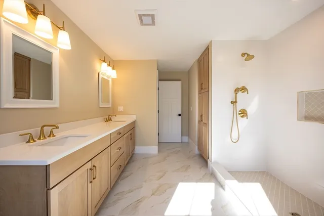 a bathroom with a double vanity sink and mirror