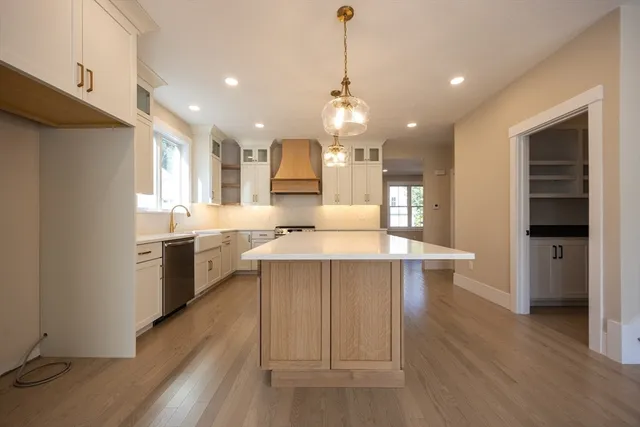 a large kitchen with a large counter top appliances and cabinets