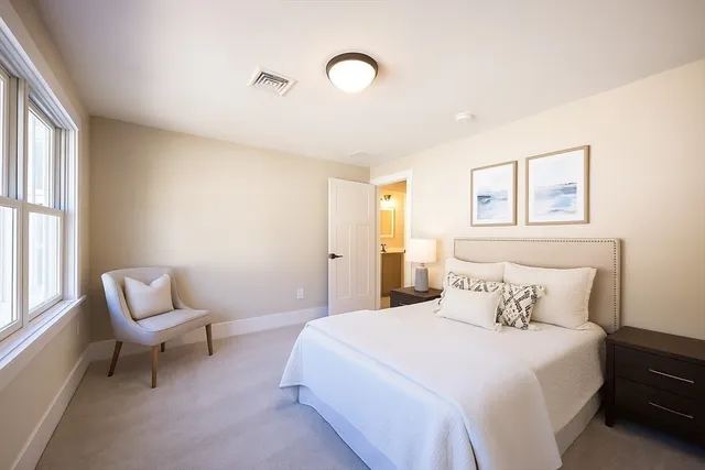 a bedroom with a bed and chair