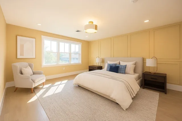 a spacious bedroom with a bed and a couch