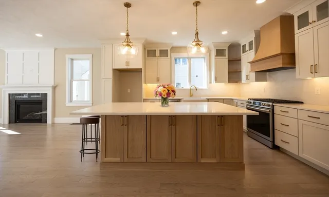 a kitchen with stainless steel appliances a sink stove and cabinets