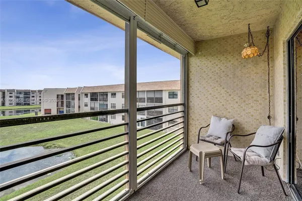a view of a chair and table in the balcony