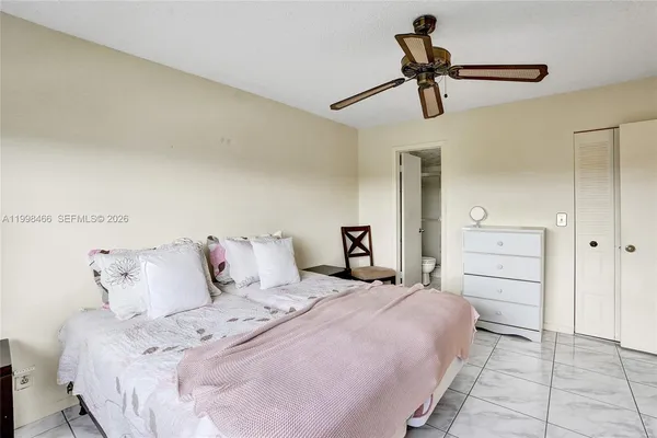 a bathroom with a granite countertop shower sink and mirror