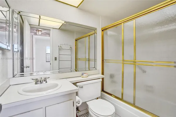 a kitchen with a refrigerator and a sink