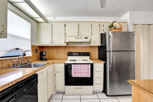a view of a kitchen with electric appliances
