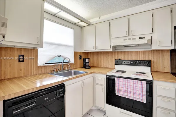 a kitchen with stainless steel appliances granite countertop a stove a refrigerator and a microwave