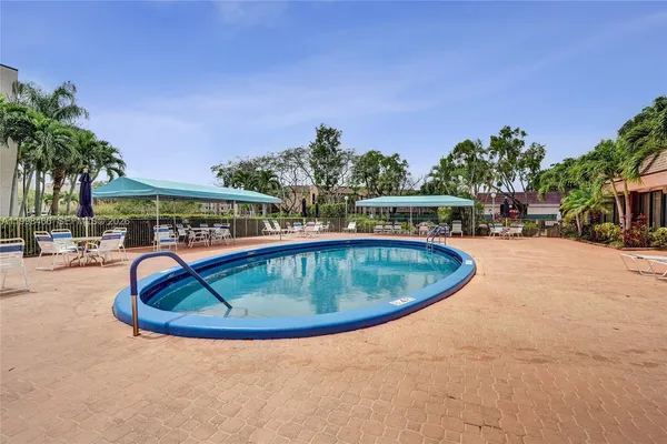 a front view of a house with porch and garden