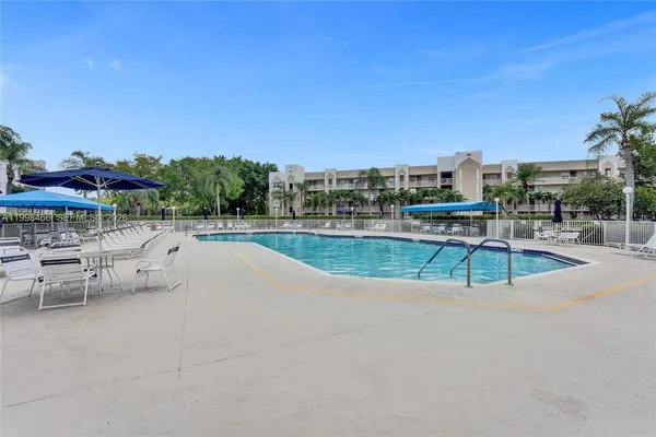 a media room with lots of chairs and many windows