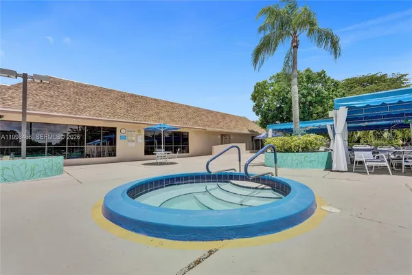 a view of a dining hall with lots of furniture and wooden floor