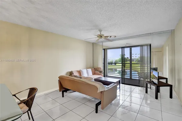 a living room with furniture and floor to ceiling window