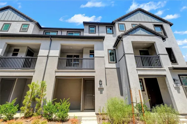 a front view of a residential apartment building with a yard