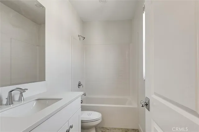 a bathroom with a toilet a sink and a bathtub
