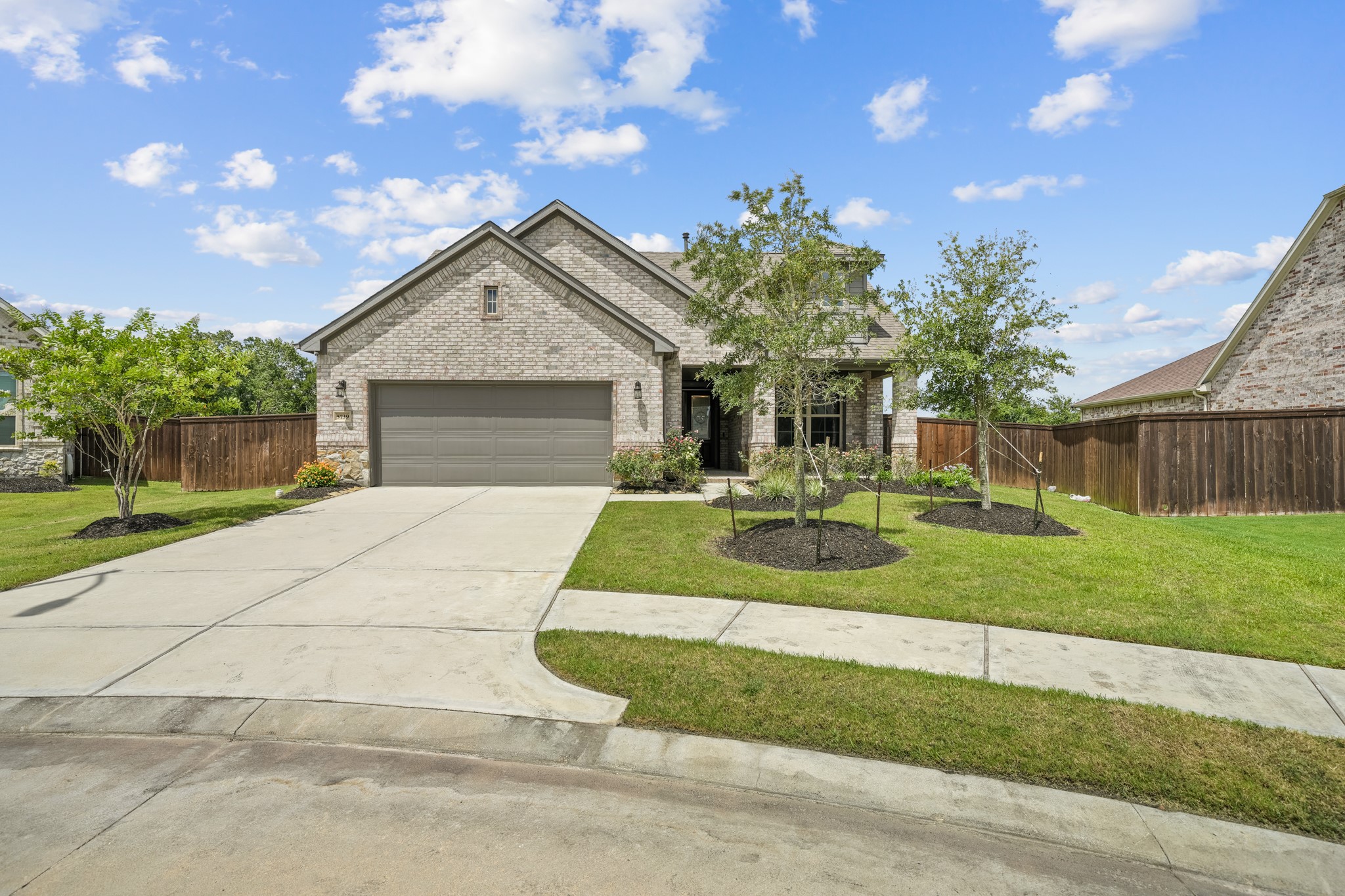 5739 Bobwhite Trail Manvel, TX 77578 - Photo 2 of 29 The attractive front elevation is complemented by a wide driveway, mature trees, and meticulously maintained grounds. Pride of ownership is evident before you even step inside.