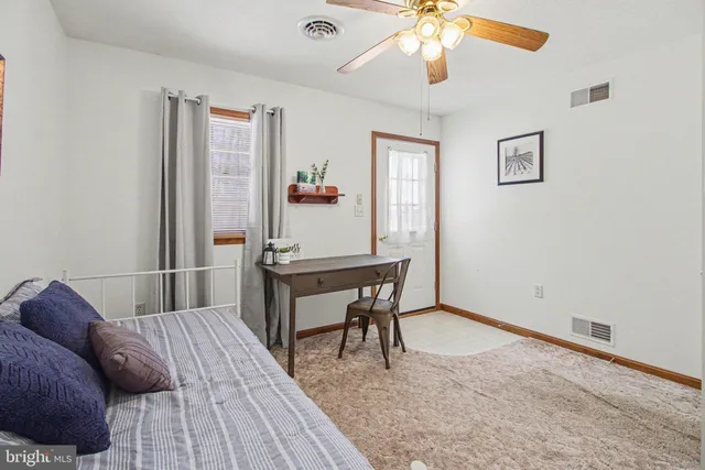 a bedroom with furniture and a chandelier