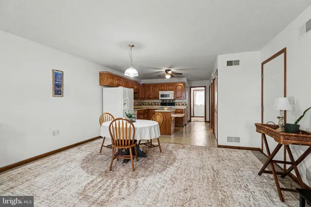 a dining room with furniture and wooden floor