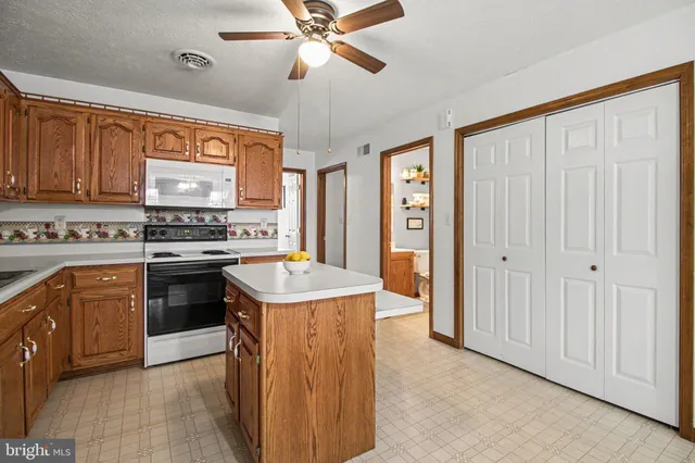 a kitchen with stainless steel appliances granite countertop a stove and a refrigerator