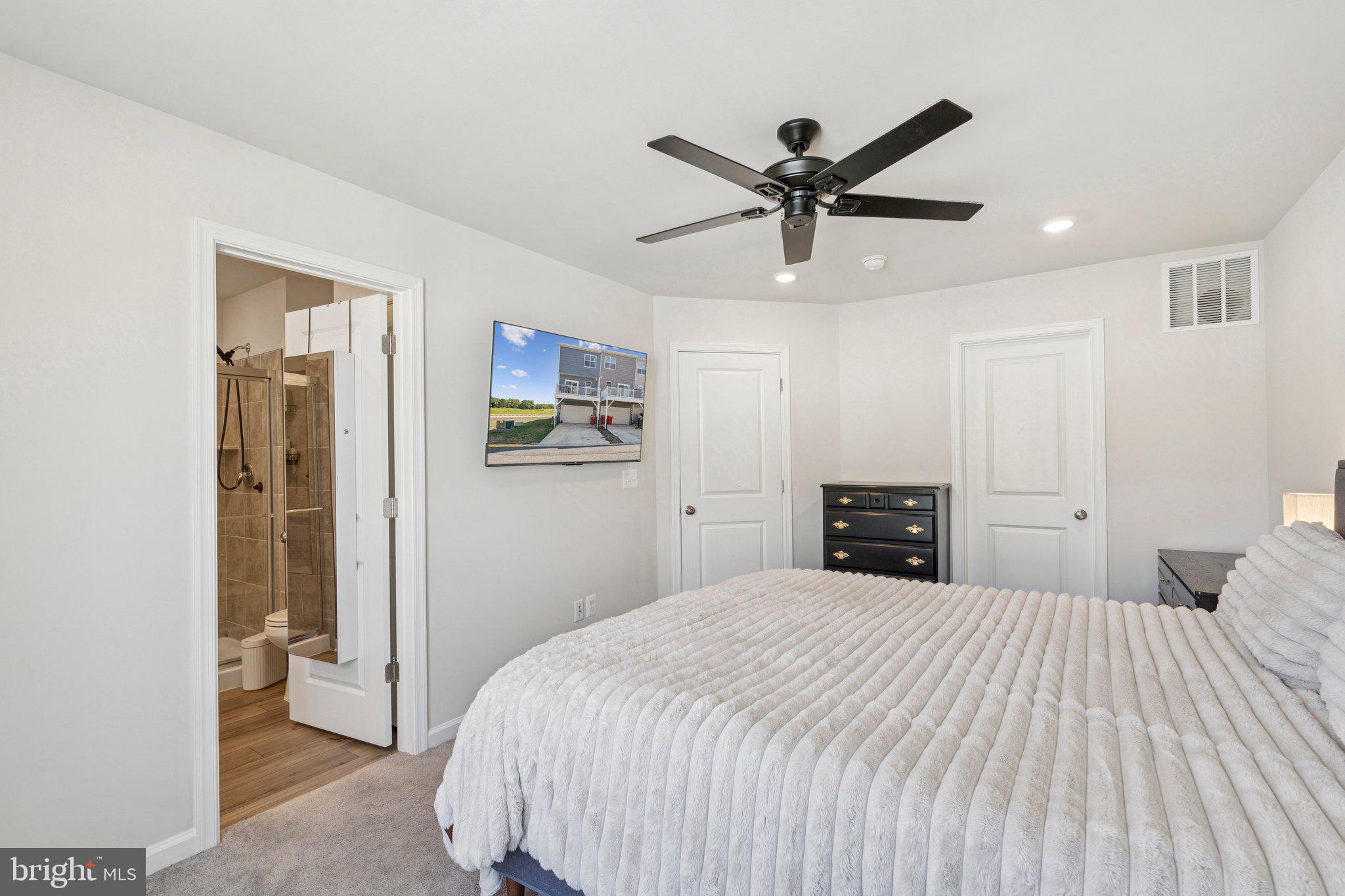 79 Swan Fld Avenue Ranson, WV 25438 - Photo 13 of 22 a bedroom with a large bed and a chandelier