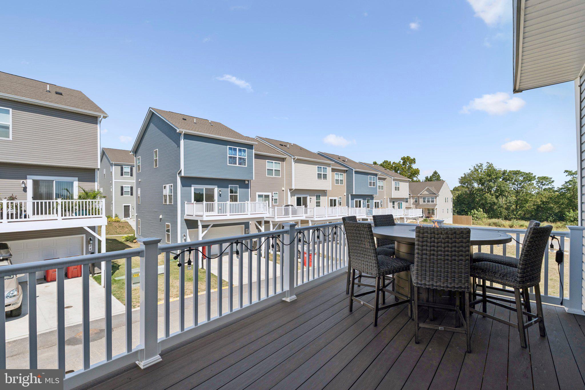 79 Swan Fld Avenue Ranson, WV 25438 - Photo 2 of 22 a view of a deck with table and chairs and wooden floor