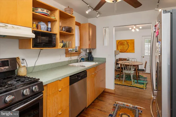 a kitchen with stainless steel appliances granite countertop a stove and a sink