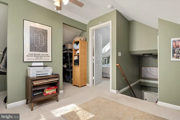 a view of a livingroom with furniture and a workspace