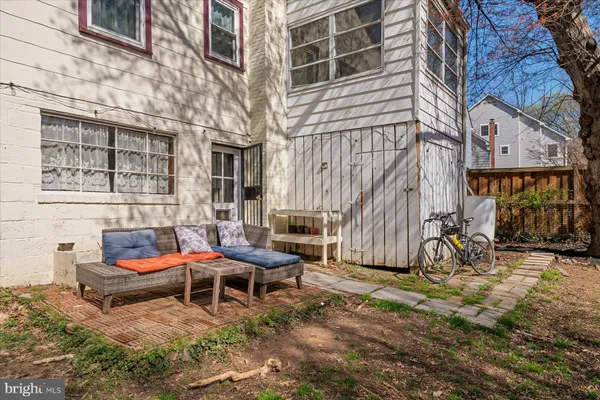 a backyard of a house with barbeque oven table and chairs