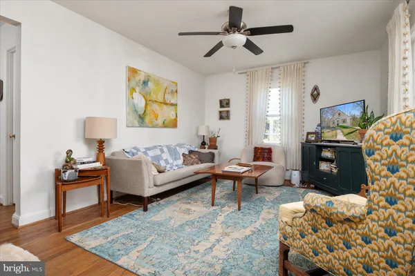 a living room with furniture a rug and a chandelier
