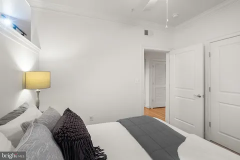 a bedroom with a bed and a lamp