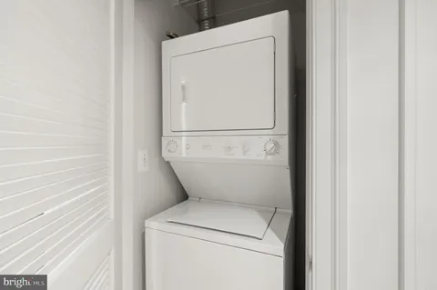 a bathroom with a granite countertop sink toilet mirror and shower