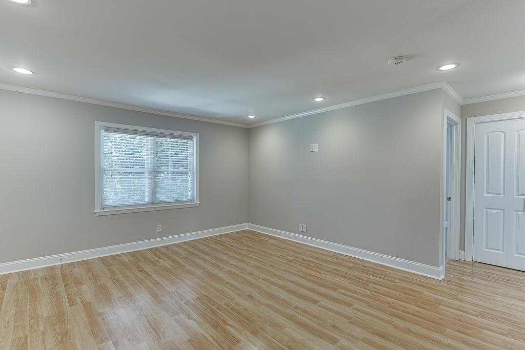 4282 Roswell Road Northeast, Unit D2 Atlanta, GA 30342 - Photo 11 of 42 wooden floor in an empty room with a window