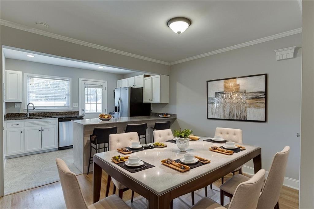 4282 Roswell Road Northeast, Unit D2 Atlanta, GA 30342 - Photo 12 of 42 a view of a dining room with furniture and wooden floor