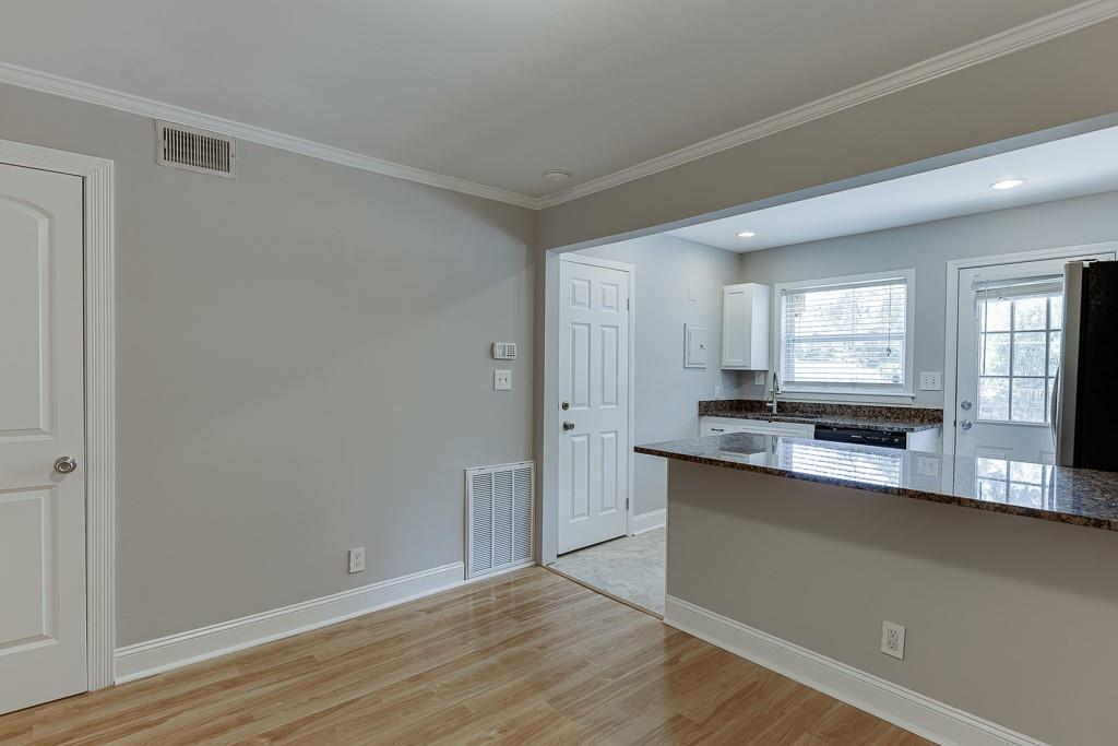 4282 Roswell Road Northeast, Unit D2 Atlanta, GA 30342 - Photo 15 of 42 a view of a kitchen with granite countertop cabinets and wooden floor