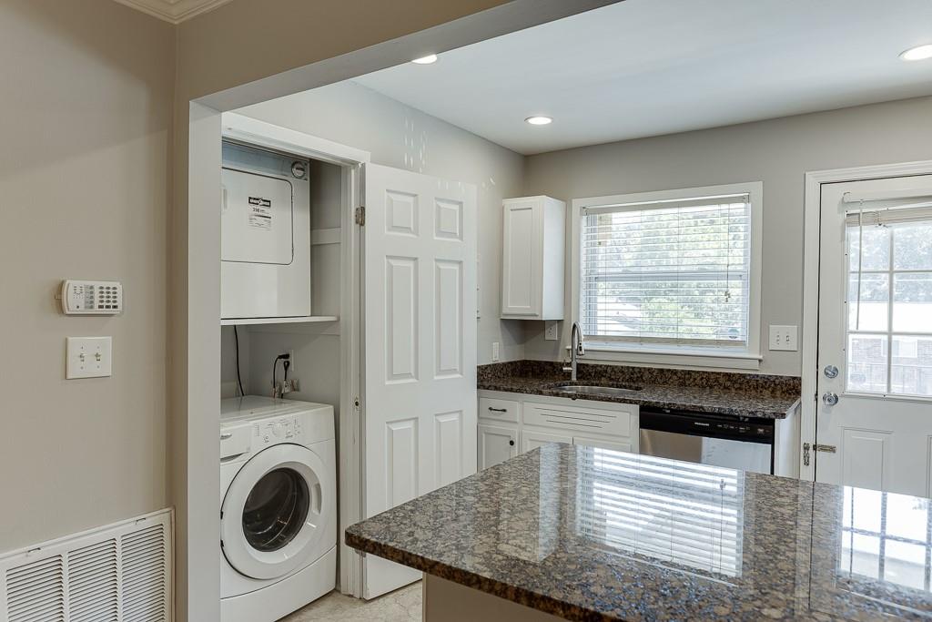 4282 Roswell Road Northeast, Unit D2 Atlanta, GA 30342 - Photo 19 of 42 a kitchen with granite countertop a stove a sink and a microwave