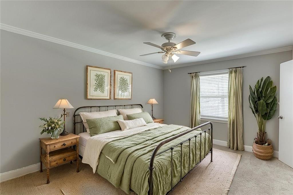 4282 Roswell Road Northeast, Unit D2 Atlanta, GA 30342 - Photo 22 of 42 a bedroom with a bed and a chandelier