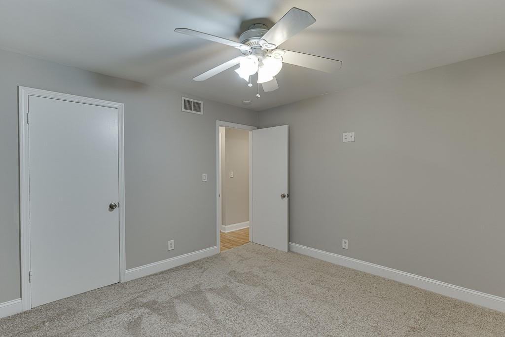 4282 Roswell Road Northeast, Unit D2 Atlanta, GA 30342 - Photo 30 of 42 an empty room with a ceiling fan and a window