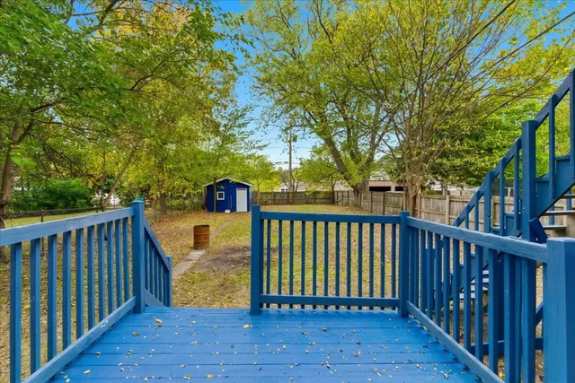 a balcony with wooden floor and fence