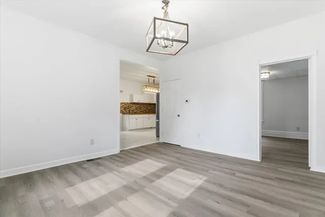 a view of a room with wooden floor