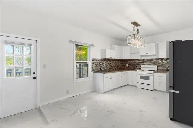 a kitchen with stainless steel appliances a refrigerator sink and cabinets