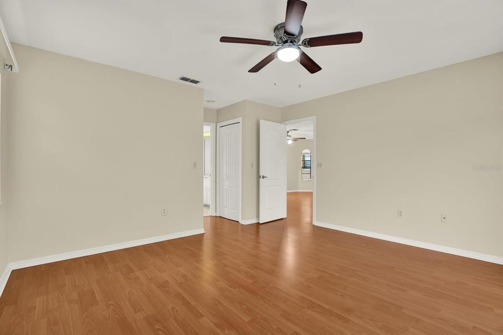 1503 Overland Drive Spring Hill, FL 34608 - Photo 12 of 24 an empty room with wooden floor ceiling fan and window