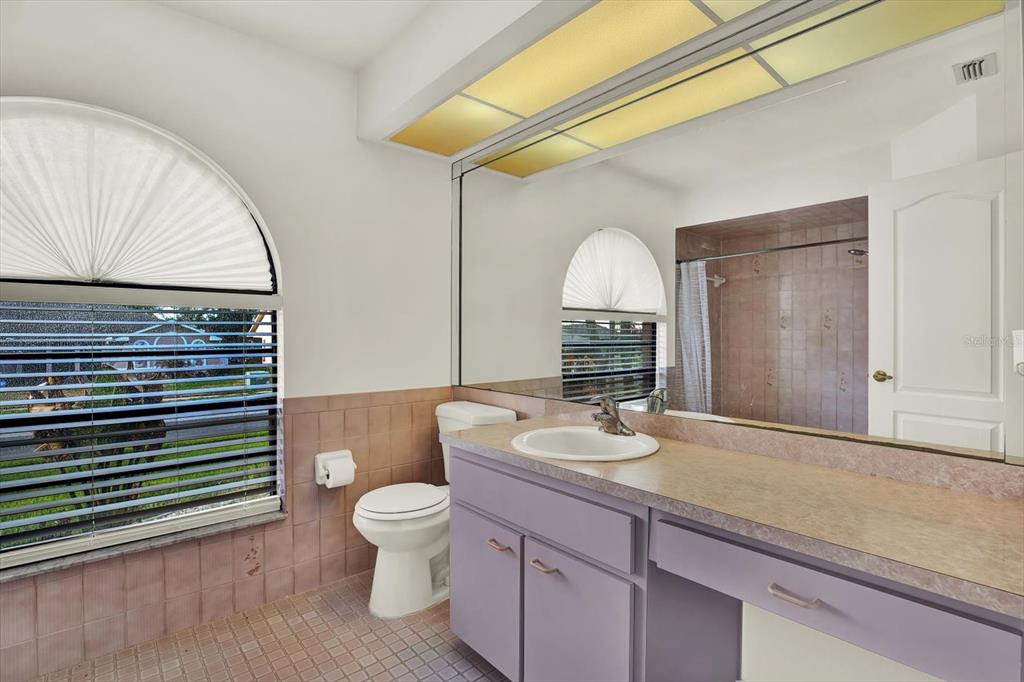 1503 Overland Drive Spring Hill, FL 34608 - Photo 13 of 24 a bathroom with a granite countertop sink mirror vanity and toilet