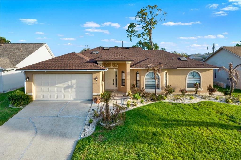 1503 Overland Drive Spring Hill, FL 34608 - Photo 20 of 24 a front view of house with yard and outdoor seating