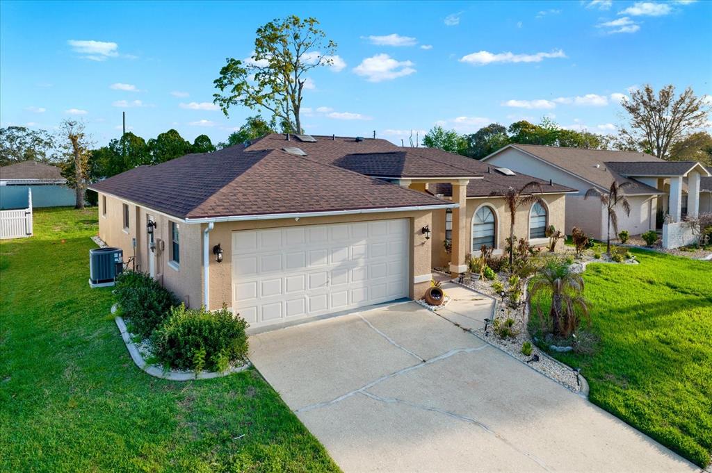 1503 Overland Drive Spring Hill, FL 34608 - Photo 21 of 24 a house with green field in front of it