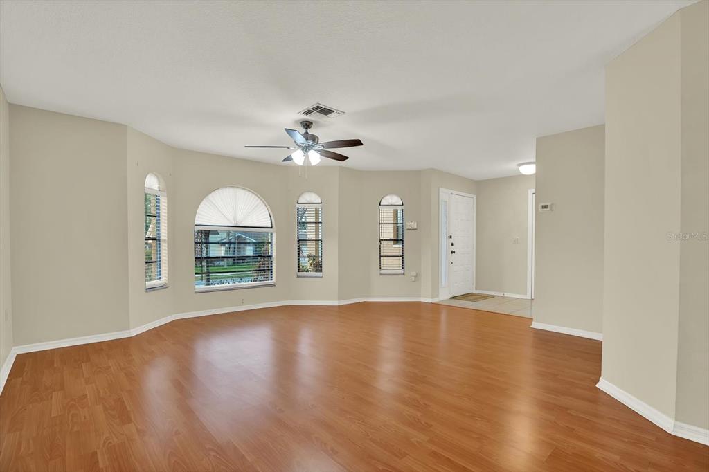 1503 Overland Drive Spring Hill, FL 34608 - Photo 5 of 24 a view of an empty room with a window and wooden floor